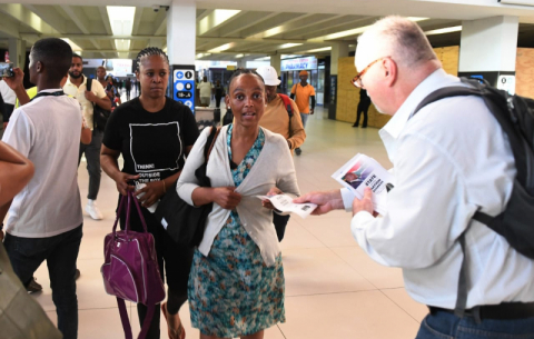 Government officials raise public awareness of the President's State of the Nation Address at the Cape Town station.