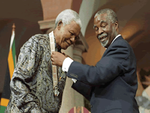 Nelson Mandela receiving an award from former President Thabo Mbeki