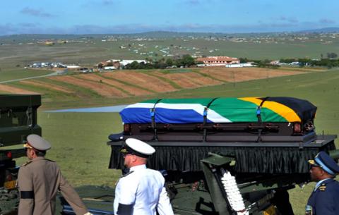 The casket of the late former President Nelson Mandela arrives at the marquee at his home. GCIS