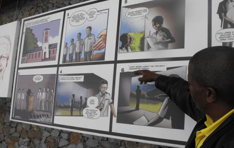 Tour guide Monde Mgodlana goes through a selection of Nelson Mandela comic series displayed at Nelson Mandela Museum in Qunu. Source: SAnews