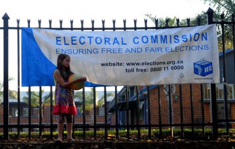 A little girl stands outside a voting station on voting day, May 7. Source: GCIS