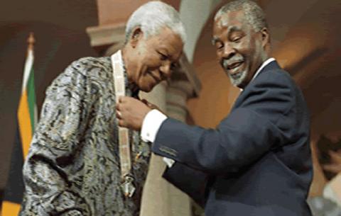 Nelson Mandela receiving an award from former President Thabo Mbeki