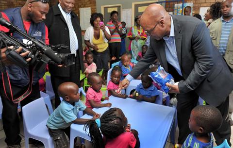 President Zuma gives children lollipops on his visit to the Muyexe Early Childhood Development Centre. Source: GCIS