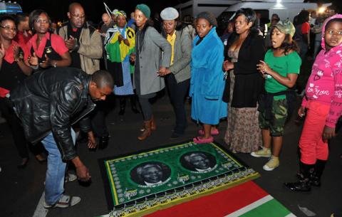 Mourners holding a night vigil in song and dance outside the late former President Nelson Mandela's Home in Houghton. Source: GCIS