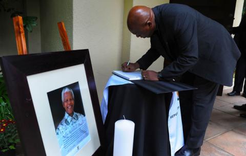 Former Minister of Human Settlements Tokyo Sexwale signing the registry book at the house Mandela's house in Houghton. Source: GCIS