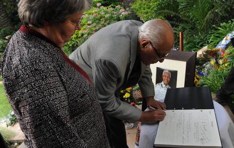 ANC stalwart Ahmed Kathrada and former Minister Barbara Hogan sign the registry book Mandela's house in Houghton. Source: GCIS  