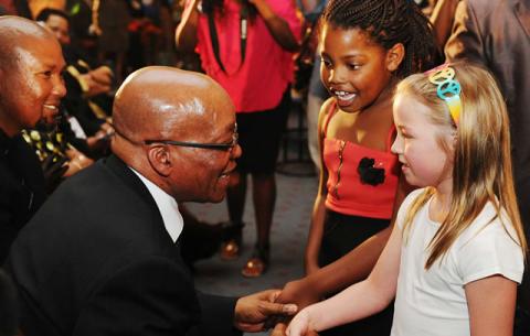 President Zuma interacts with children at Bryanston Methodist Church at a prayer service for Madiba. Source: GCIS