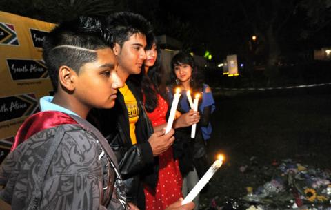South Africans gather to light candles outside Madiba’s home in Houghton Johannesburg. Source: GCIS