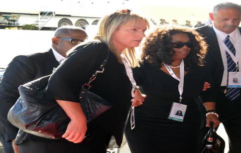Oprah Winfrey, partner Stedman Graham and Zelda La Grange arrive at the state funeral of former President Nelson Mandela. Qunu, Eastern Cape. Source: GCIS