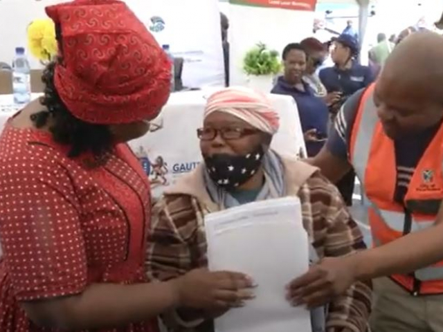 Minister Kubayi handing over newly built houses and title deeds to qualifying beneficiaries in Devon