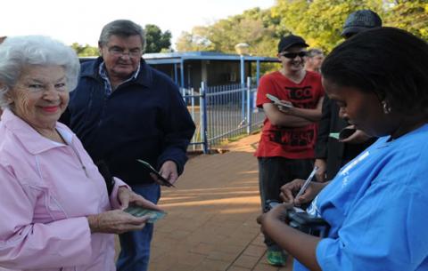 An elderly couple is assisted by electoral staff on May 7. Source: GCIS