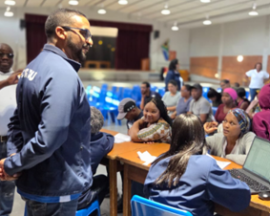 MEC Simmers with housing beneficiaries.